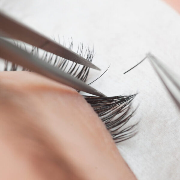 Lash Treatment, Traditional eyelash extensions. Selective focus. Toned. Makeup close-up.